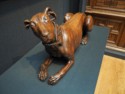 A wooden sculpture of a dog